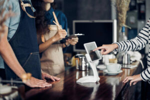 customer self service order drink menu with tablet screen at cafe counter bar,seller coffee shop accept payment by mobile.digital lifestyle concept.Blank space for display of design